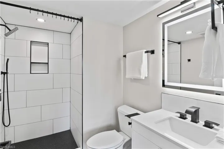 Modern guest bathroom with an all-new walk-in shower and a light-up mirror that adds a touch of sophistication and convenience.