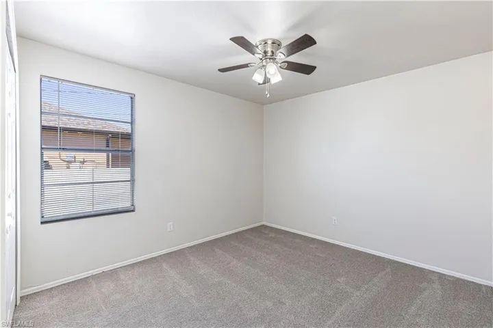 Unfurnished room with carpet floors and ceiling fan