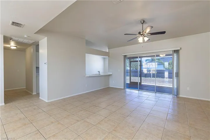 Spare room with light tile patterned floors and ceiling fan