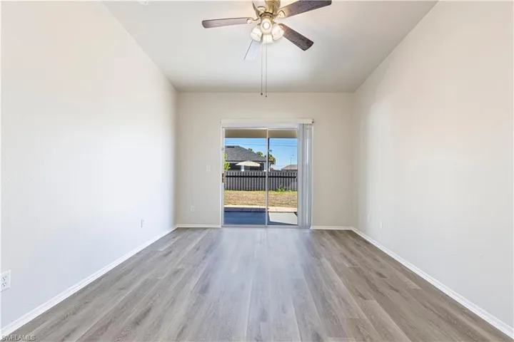 Spare room with light wood-style floors and a ceiling fan