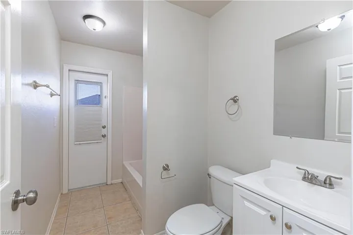 Bathroom featuring vanity, light tile patterned floors, and bathtub / shower combination