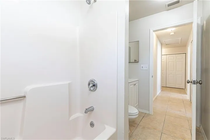 Full bathroom featuring light tile patterned floors, shower / tub combination, and vanity