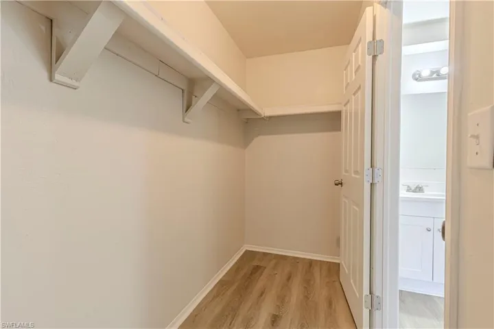 Walk in closet featuring light wood-style floors