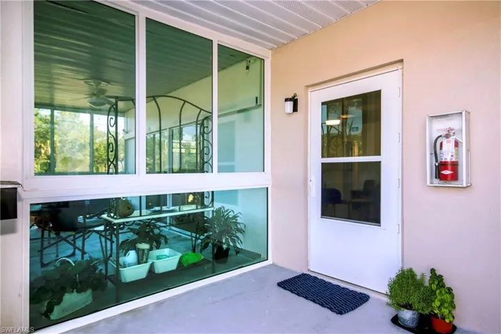Doorway to property featuring stucco siding
