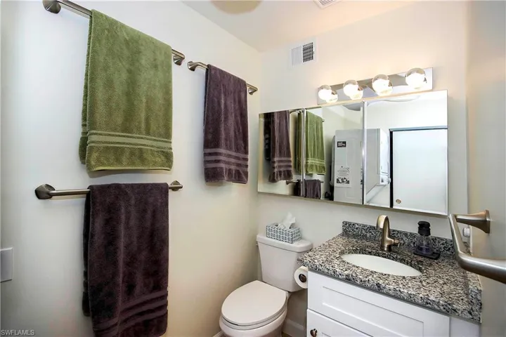 Bathroom with visible vents, toilet, and vanity