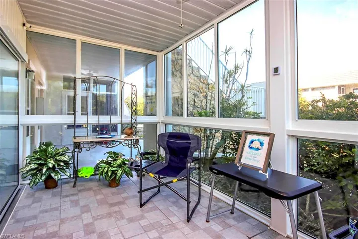 Sunroom with plenty of natural light and floor to ceiling windows
