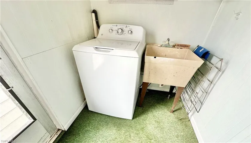 Clothes washing area with washer / clothes dryer and carpet floors