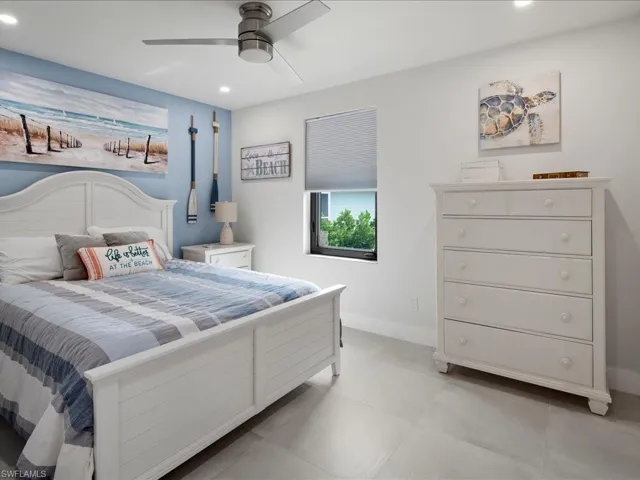 Bedroom featuring light tile patterned floors and ceiling fan