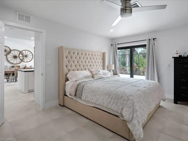 Tiled bedroom with ceiling fan