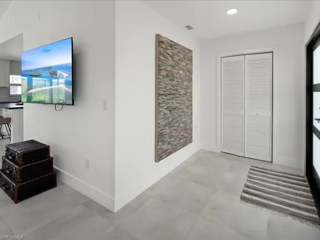 Hall featuring light tile patterned floors