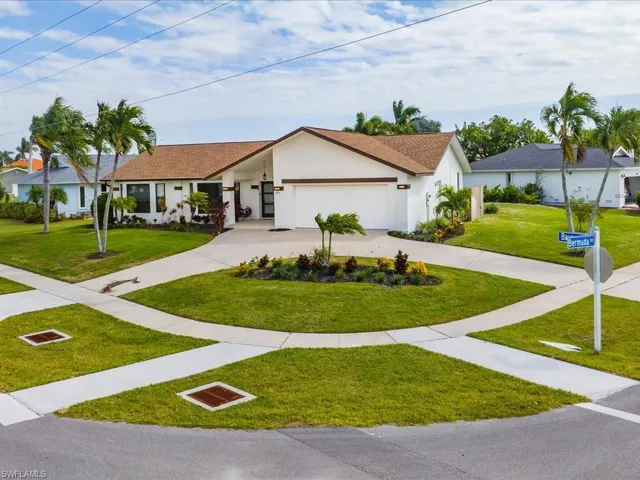 Single story home with a garage and a front yard