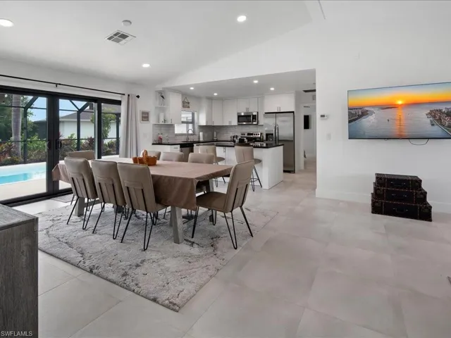 Tiled dining room with french doors and vaulted ceiling