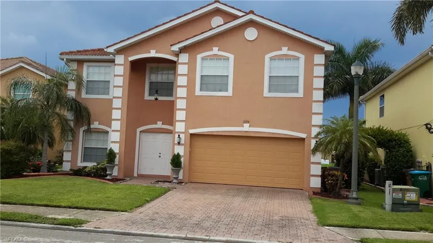 Mediterranean / spanish home with a front lawn, a garage, stucco siding, decorative driveway, and a tiled roof