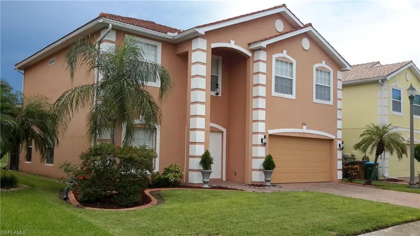 Mediterranean / spanish-style house featuring concrete driveway, stucco siding, a garage, and a front lawn