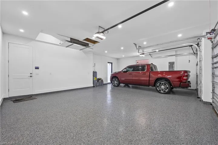 Garage featuring a garage door opener and electric panel