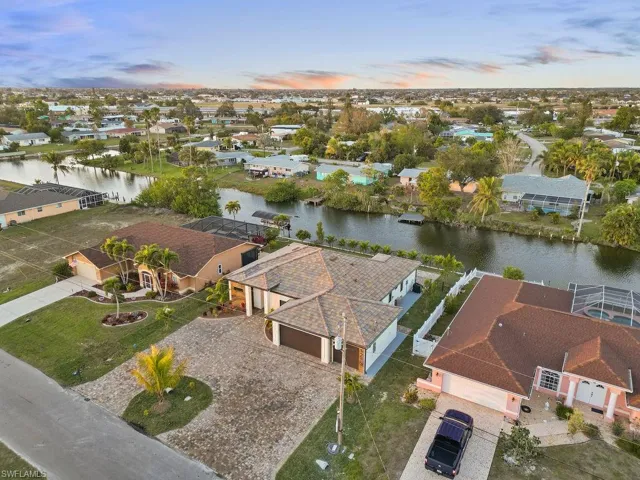 Aerial view at dusk featuring a water view