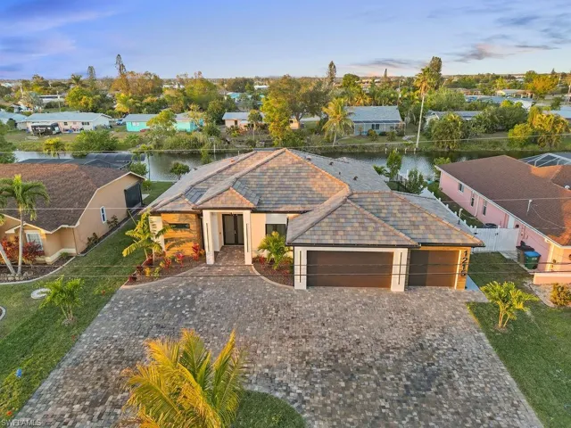 Birds eye view of property with a water view