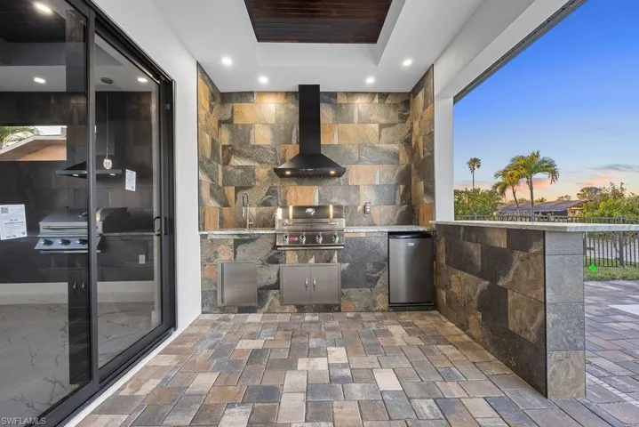 Patio terrace at dusk with area for grilling and sink