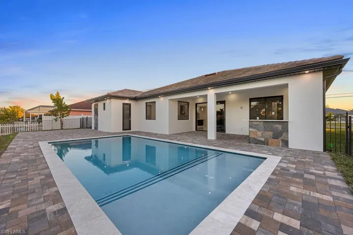 Pool at dusk with a patio