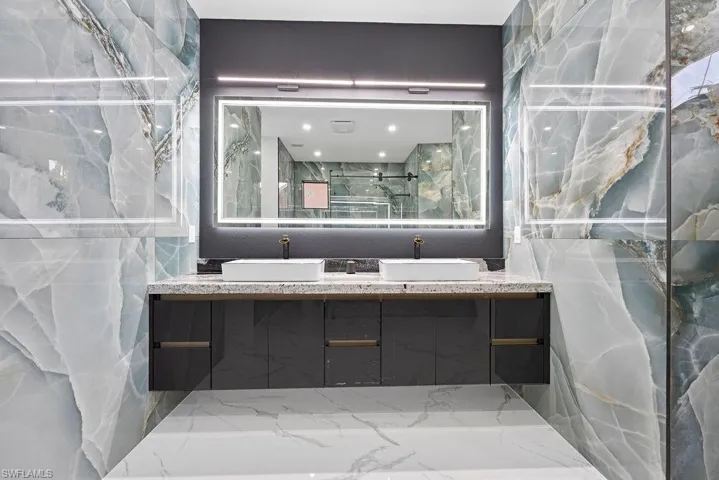 Bathroom featuring walk in shower and vanity