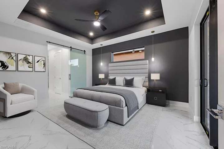 Virtual Stage-Bedroom featuring a raised ceiling, a barn door, and ceiling fan