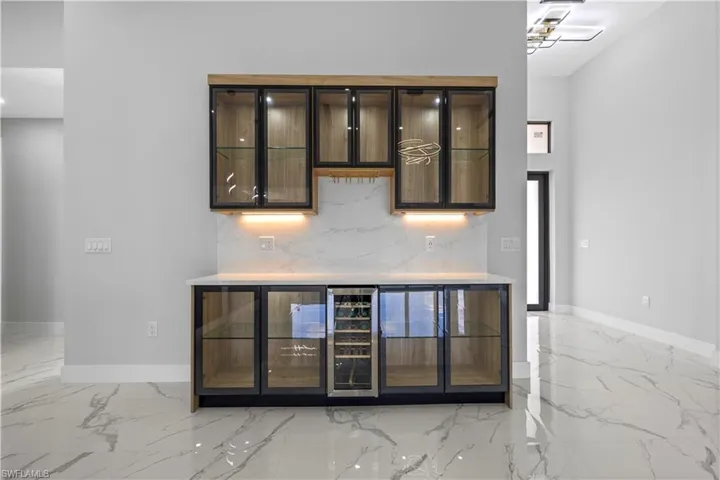 Bar featuring tasteful backsplash