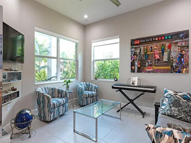 Living area with tile patterned flooring and recessed lighting