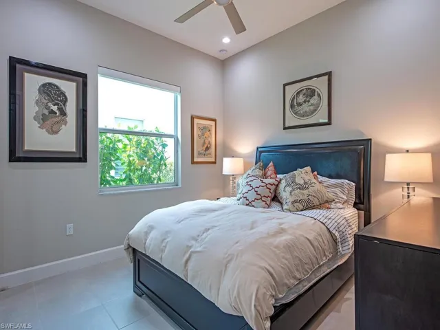 Bedroom with a ceiling fan, recessed lighting, and light tile patterned flooring