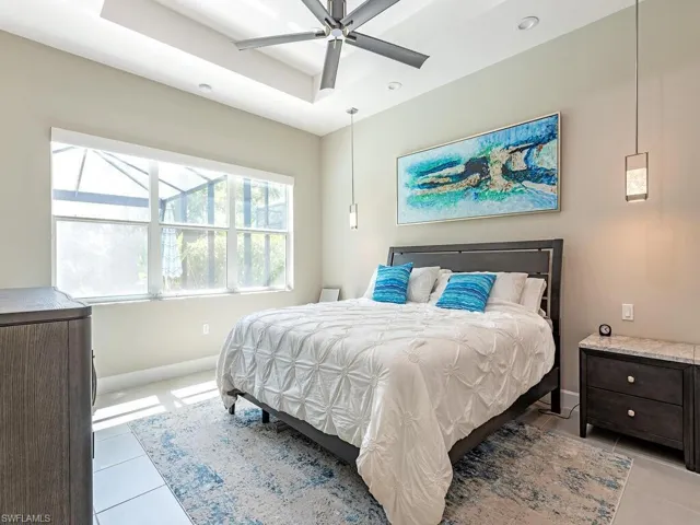 Bedroom with light tile patterned floors, ceiling fan, and recessed lighting