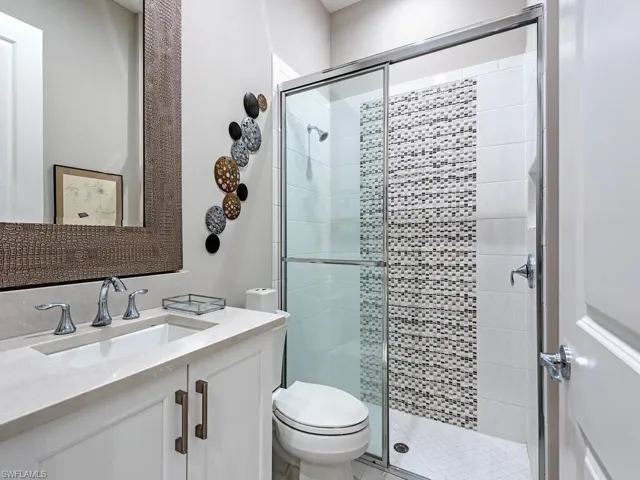Full bathroom featuring vanity and a stall shower