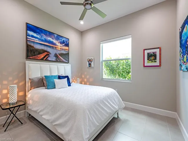 Bedroom with a ceiling fan, light tile patterned flooring, and recessed lighting