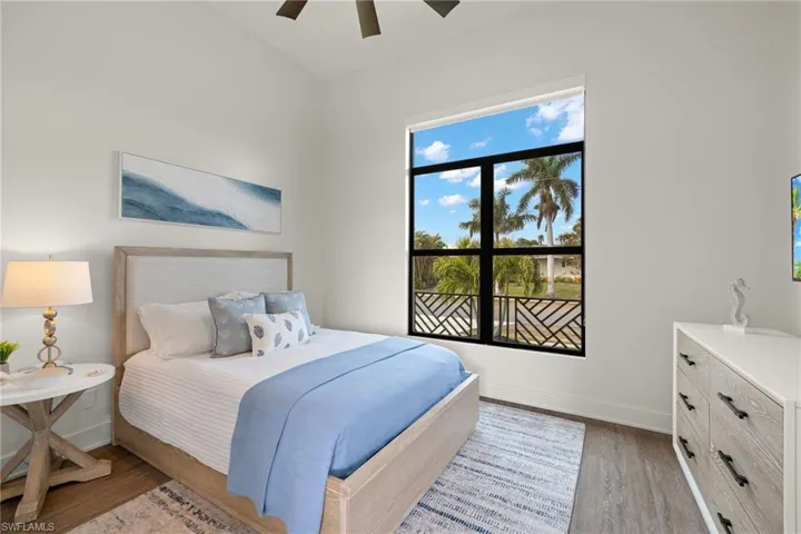 Bedroom with ceiling fan and hardwood / wood-style floors