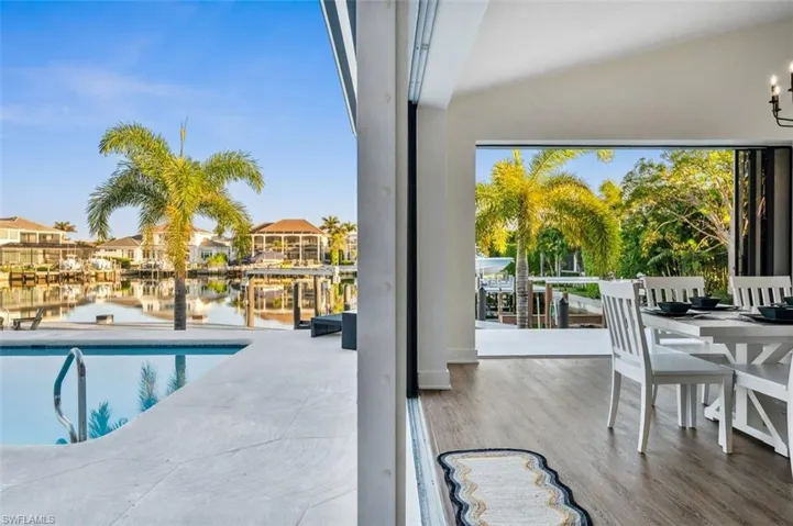 View of pool featuring a patio and a water view
