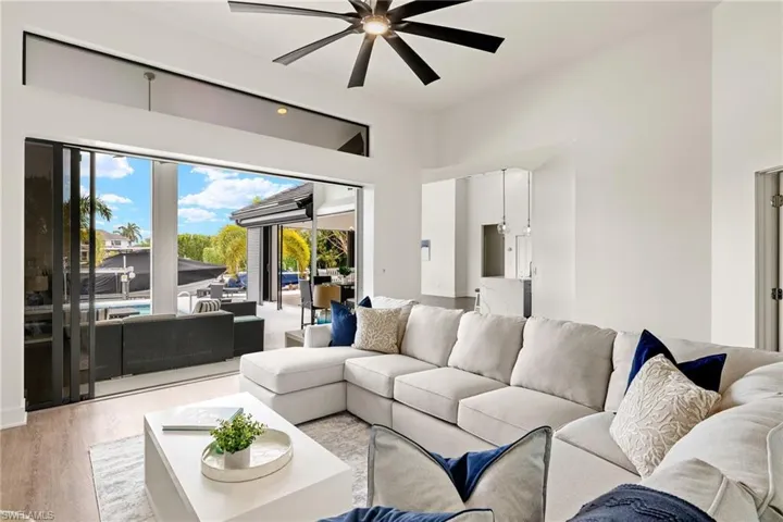 Living room featuring ceiling fan and light hardwood / wood-style flooring