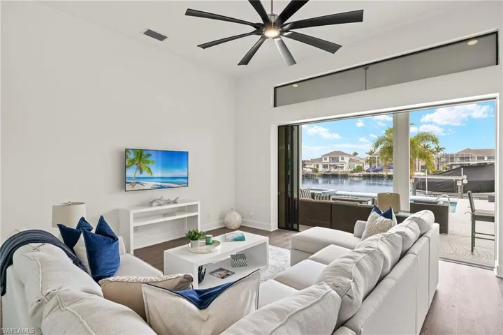 Living room featuring ceiling fan and light hardwood / wood-style flooring