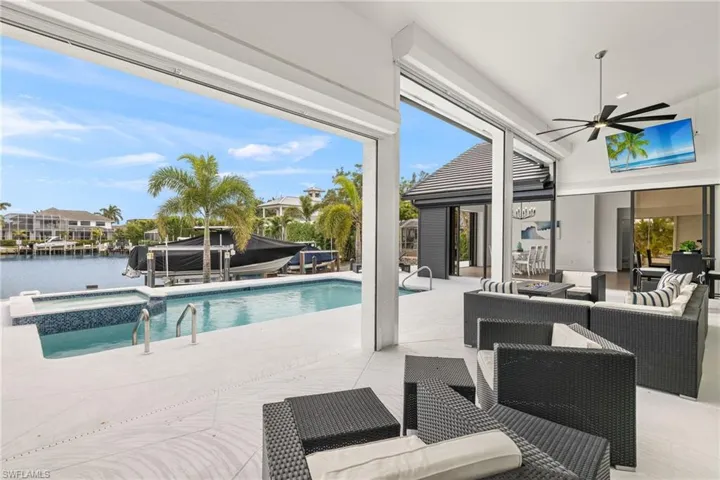 View of pool with an in ground hot tub, a water view, an outdoor hangout area, and a patio area