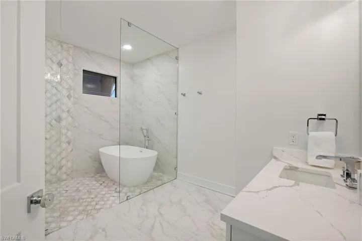 Bathroom featuring vanity and a washtub
