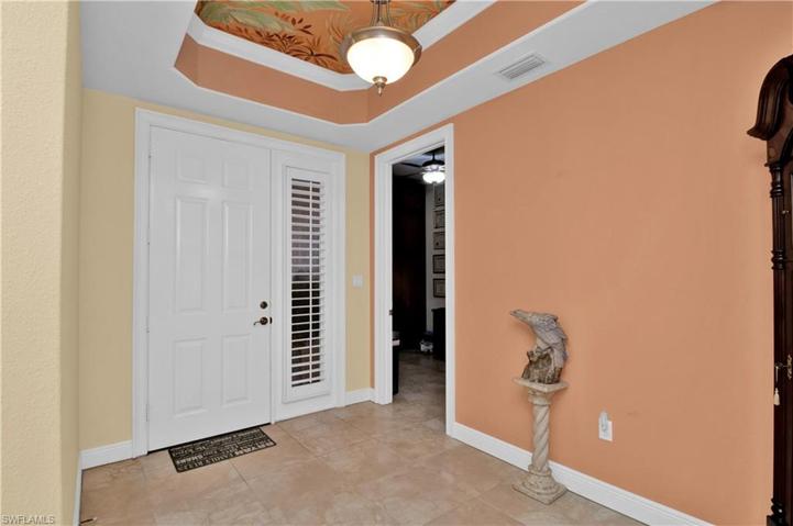 Spacious entry with custom painted tray ceiling
