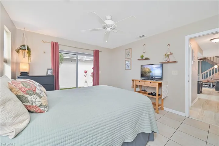 Bedroom featuring light tile patterned flooring and a ceiling fan