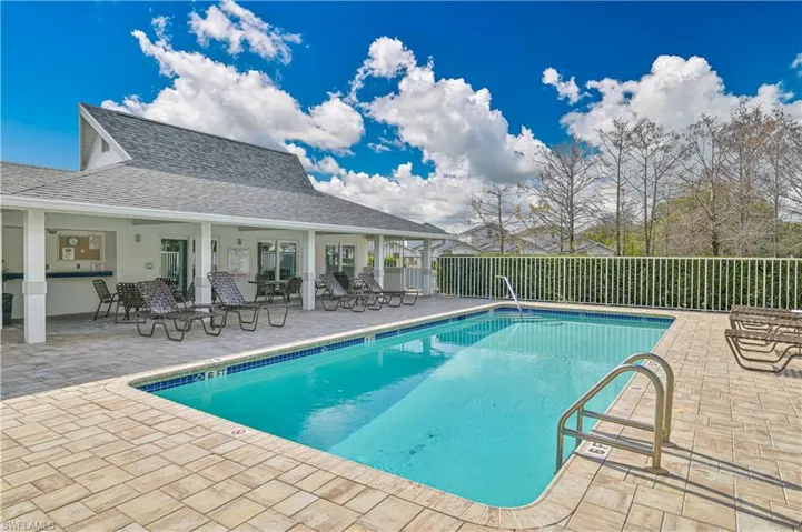 Community pool featuring a patio