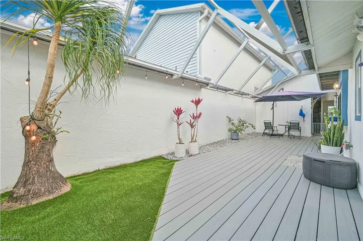 Wooden deck featuring a lawn