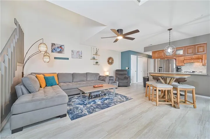 Living area with a ceiling fan and light wood-type flooring