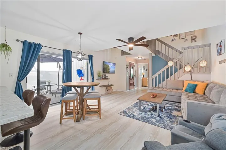 Living room featuring light wood finished floors and suspended lighting