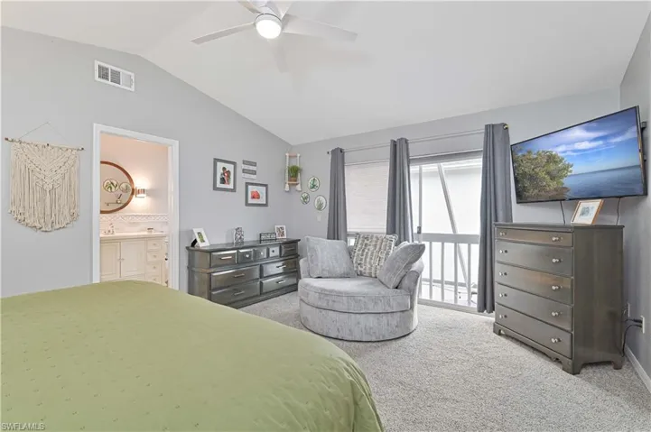 Bedroom featuring carpet floors, ceiling fan, connected bathroom, and access to outside