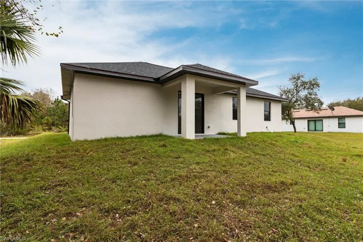 Back of property featuring a yard