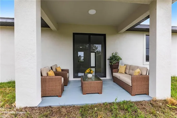Entrance to property with an outdoor hangout area and a patio area