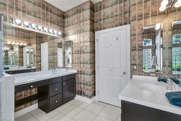 Bathroom featuring tile patterned flooring and vanity