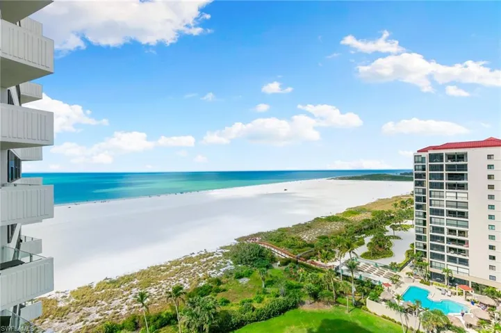 Balcony featuring view of water and beach