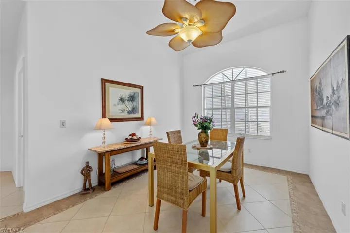 Dining space featuring ceiling fan and light tile patterned flooring