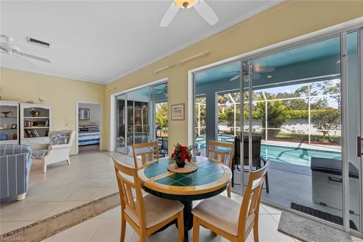 Tiled dining space featuring crown molding